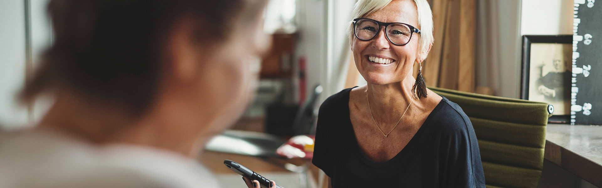 happy-woman-smiling-in-office-setting happy-woman-smiling-in-office-setting