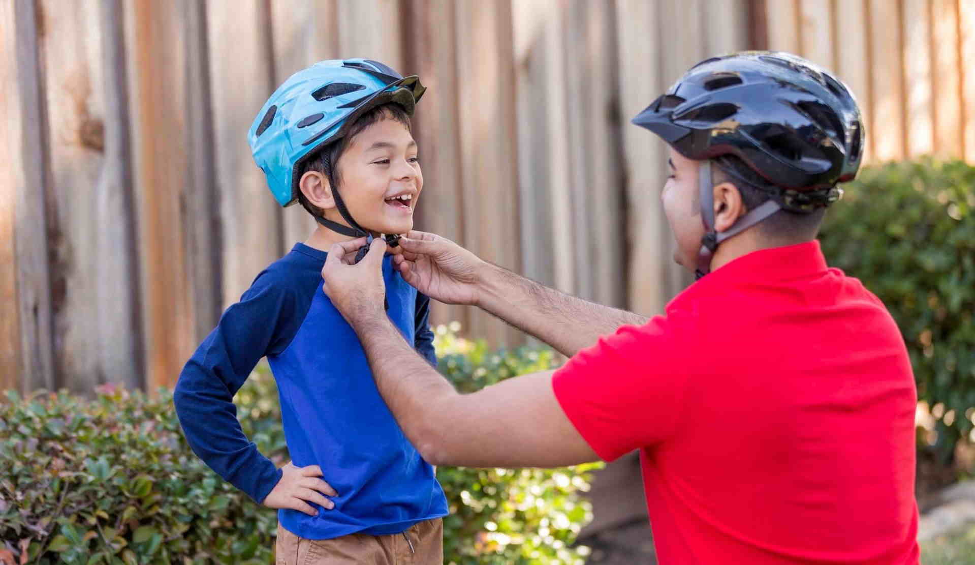 dad-helping-son-with-helmet