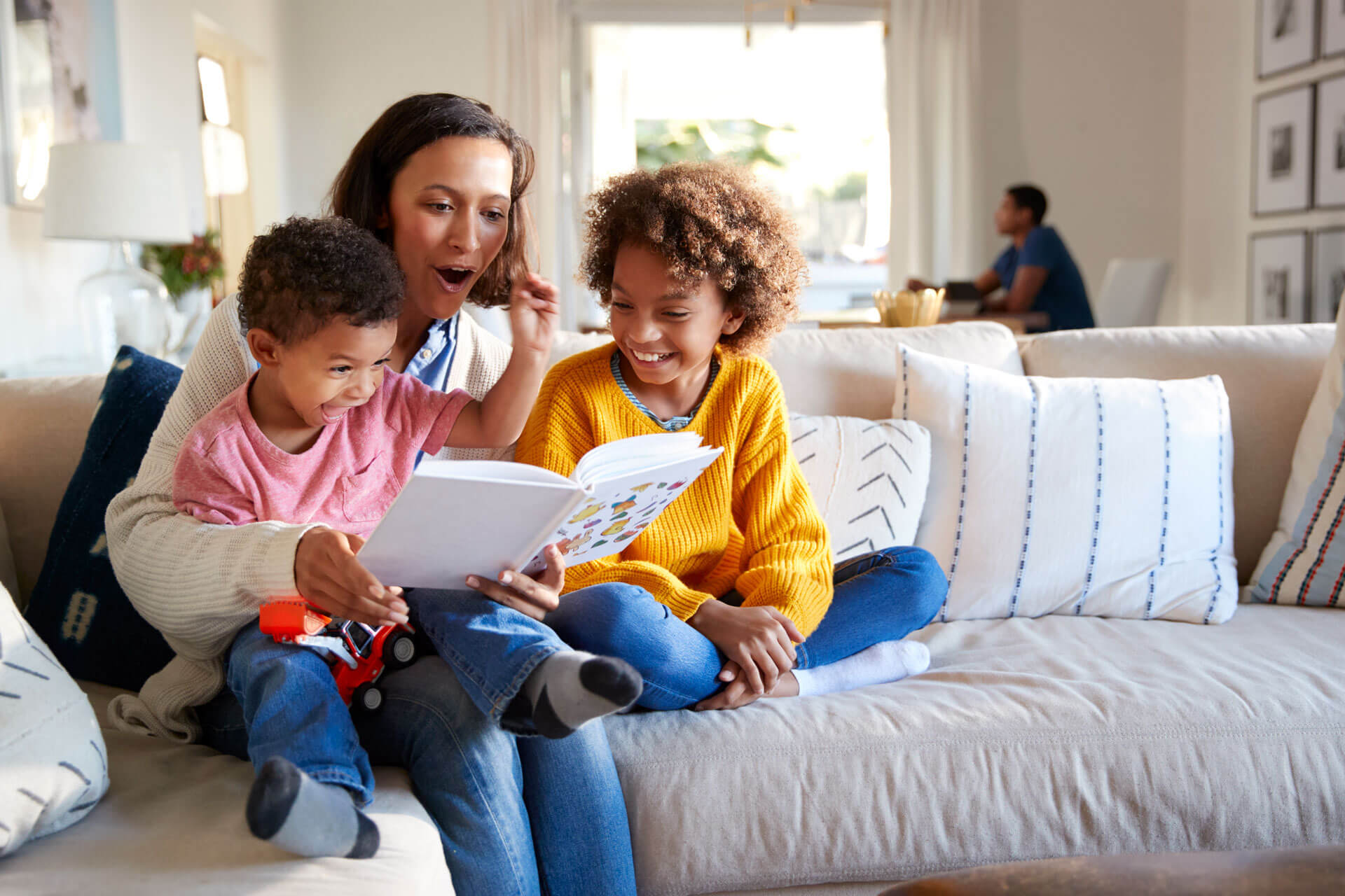 Family reading - banner Family sitting on a couch and reading.