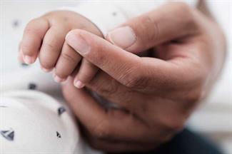 father-holding-newborn-baby-hand