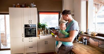 father-on-phone-holding-baby