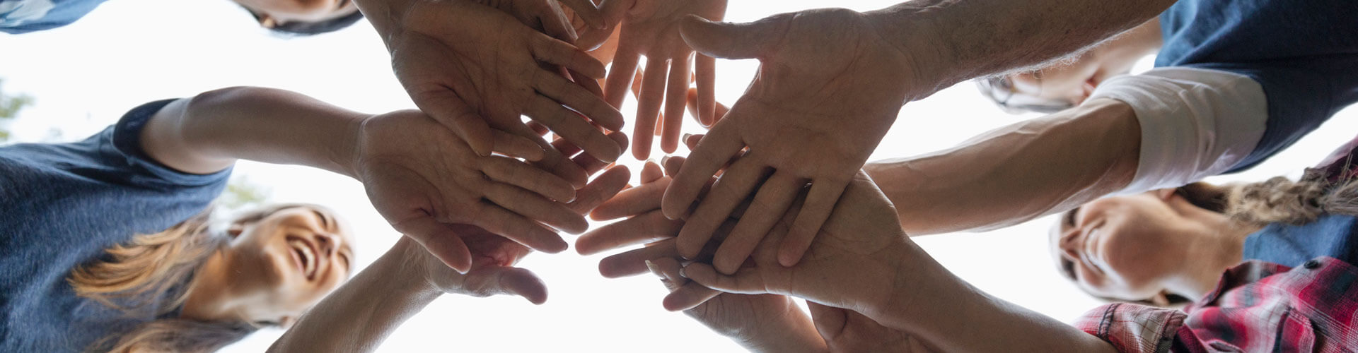 group-of-volunteers-with-hands-together-in-circle