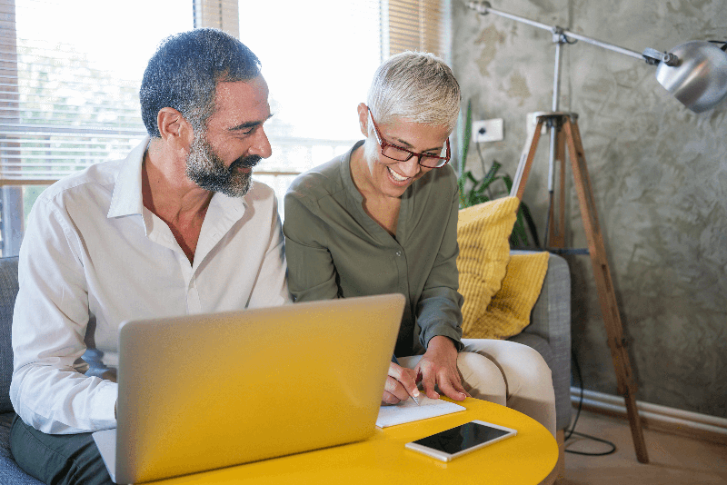 Work with a life insurance advisor man and woman working on electronic paperwork on laptop