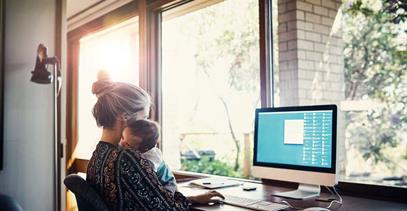 mom-holding-baby-while-on-computer
