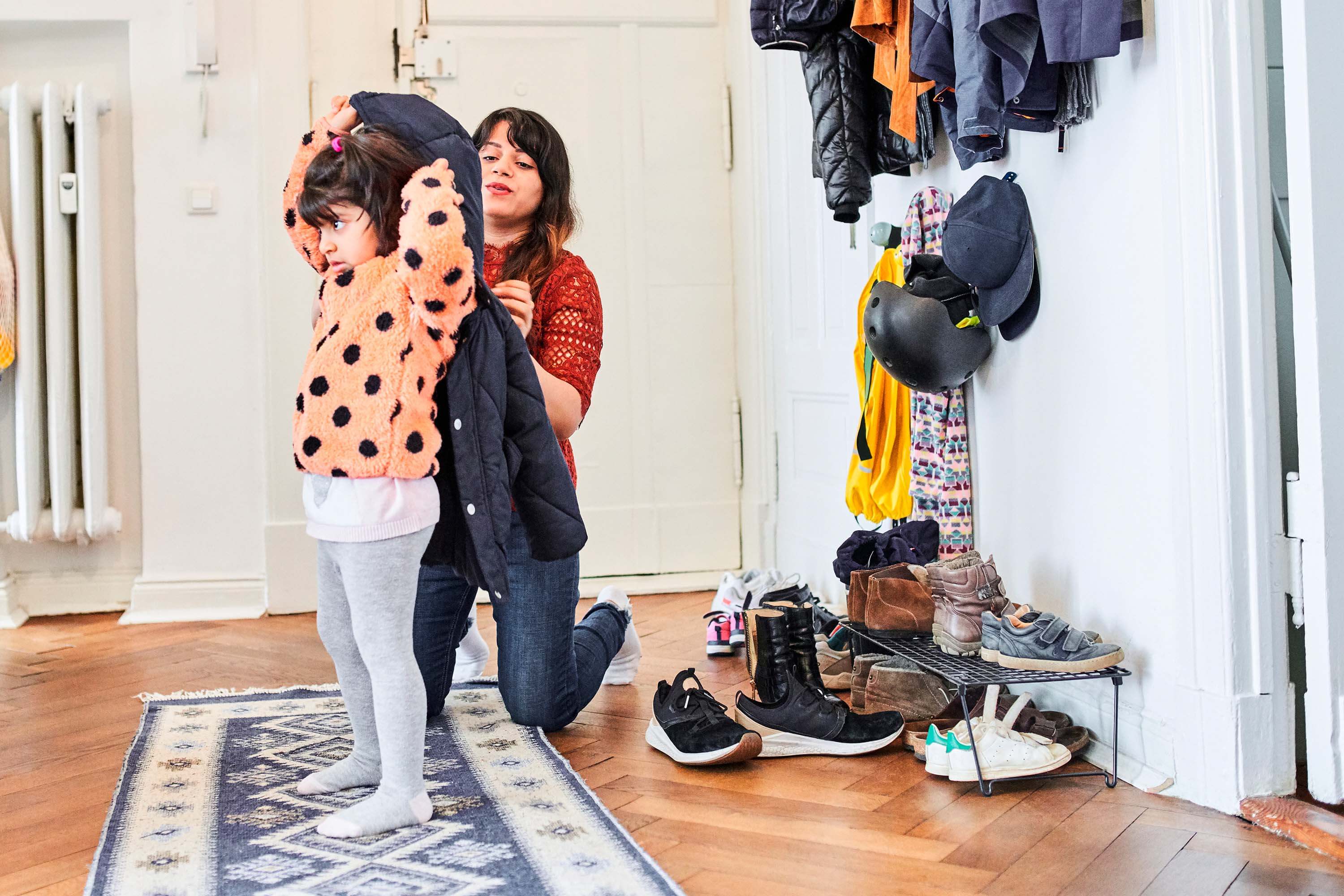 mom-putting-on-childs-winter-coat mom-putting-on-childs-winter-coat