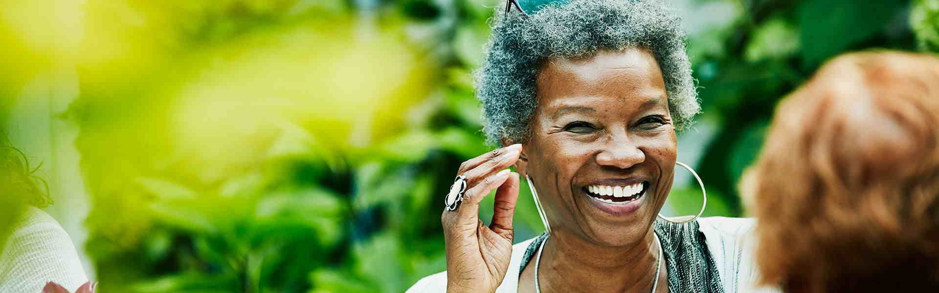 woman-laughing-with-friend-in-garden